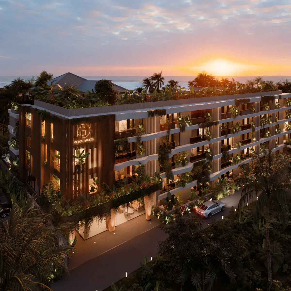 A modern apartment building with greenery and illuminated balconies at sunset, featuring a rooftop garden and a car parked in front.