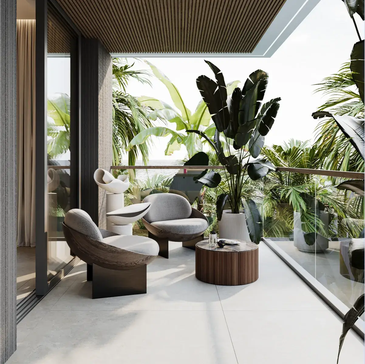 Modern outdoor seating area with stylish armchairs, a small round table, decorative sculptures, and large tropical plants on a balcony overlooking greenery.